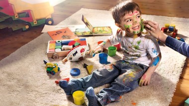 Cleaning with water - mother cleans dirty child